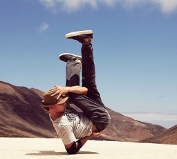 Breakdancer on one elbow environmental portrait of alternative athlete
